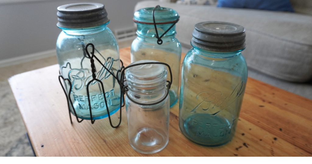 Blue mason jars and one small clear lidded vintage jar