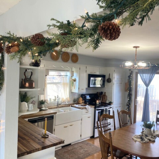 Garland over walkway with view of kitchen decorated for Christmas