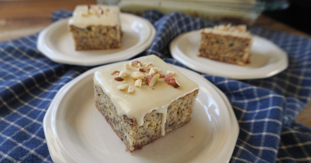 3 pieces of cake on 3 plates with chopped nuts on top