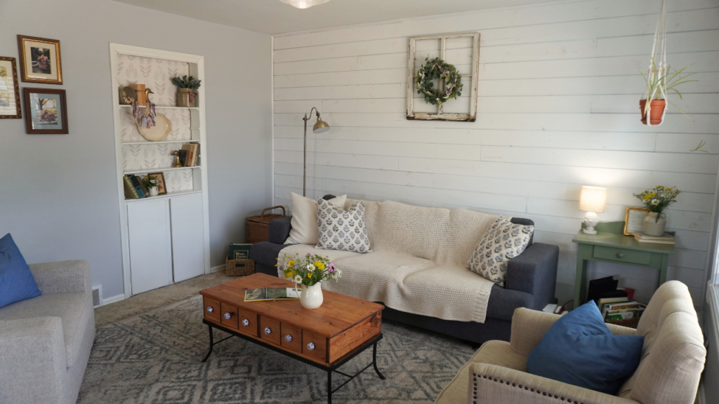 living room with flowers on coffee table couch side table with flowers and built-ins with books and flowers and American decor
