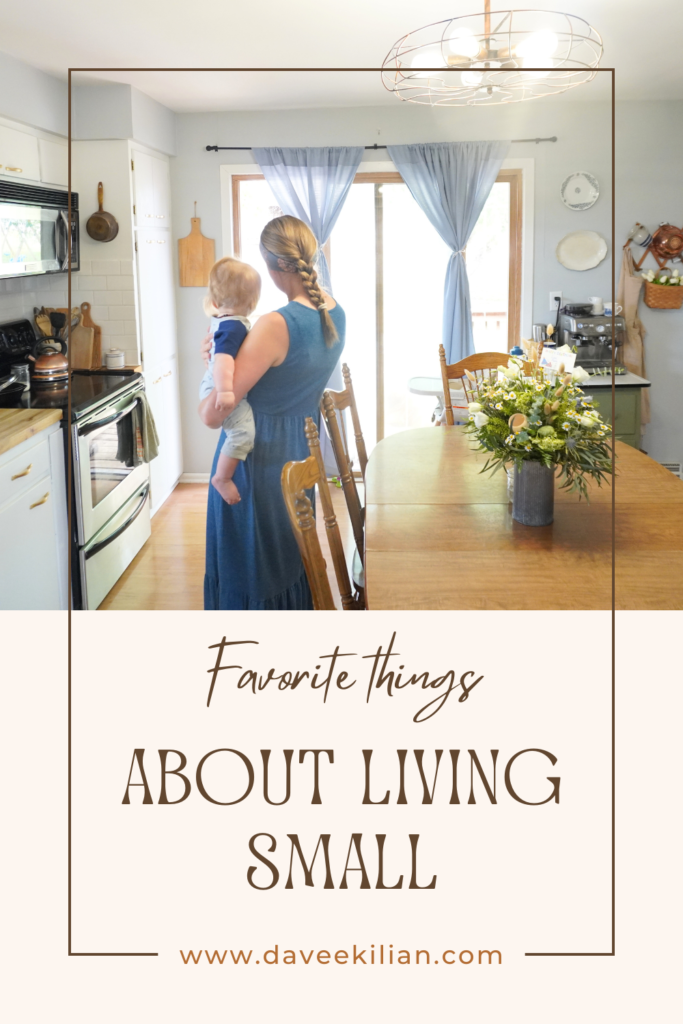 Living small pin woman holding baby in kitchen