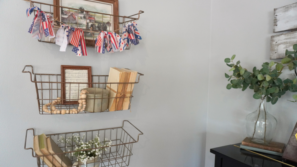 3 wire shelves with picture frames, patriotic banner crocks and books