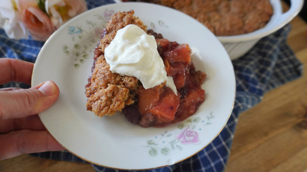 holding plate with cobbler with cream on top